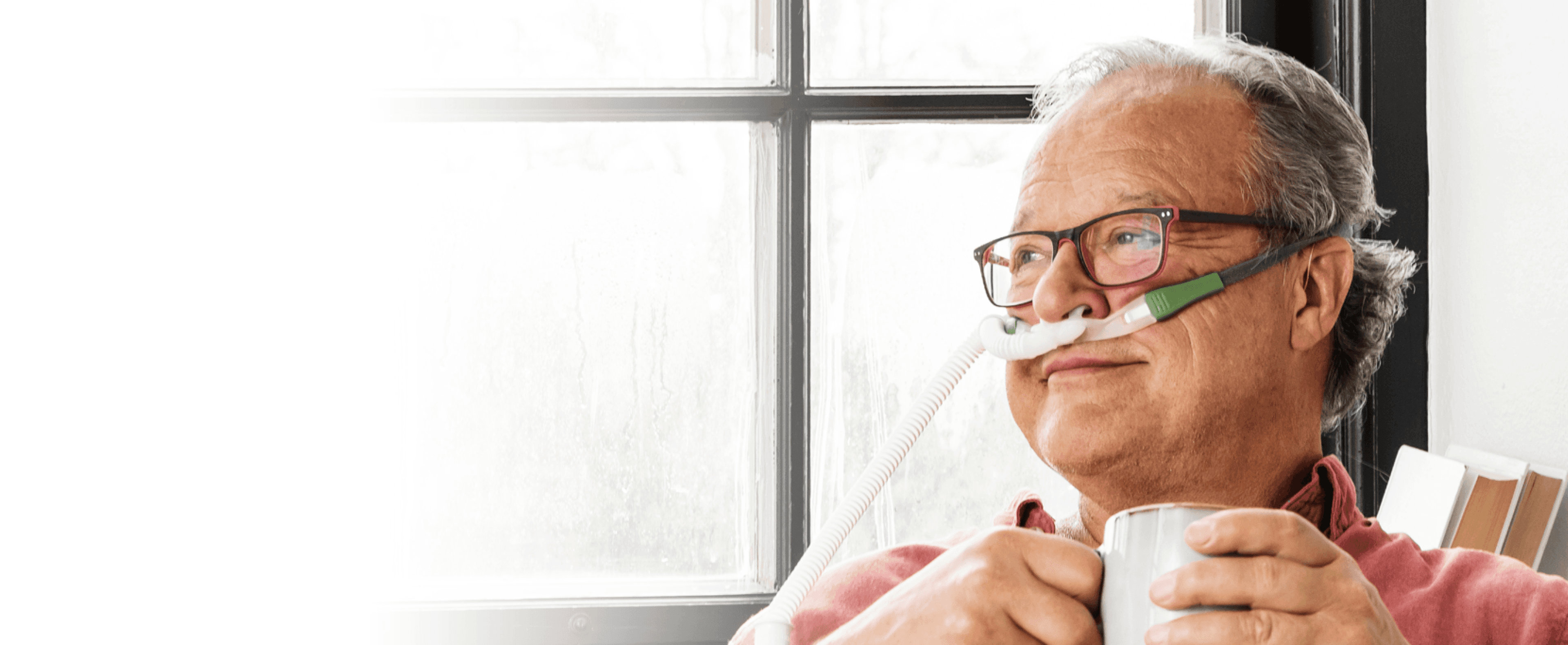 A man receiving care at home with a device from Breas